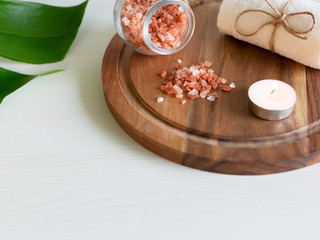 Pink Himalayan salt and towel on wooden plank