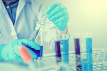 Scientist with equipment holding tools during scientific experiment science concept