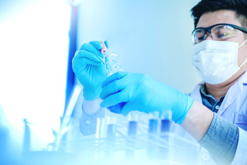 Scientist with equipment holding tools during scientific experiment science concept