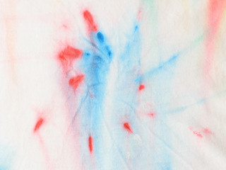 A piece of fabric painted in tie dye style.