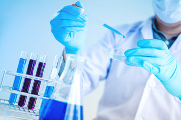 Scientist with equipment holding tools during scientific experiment science concept