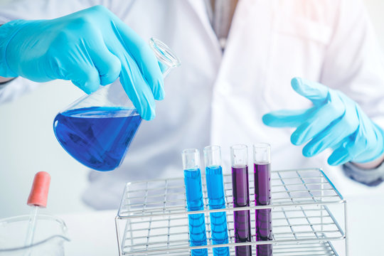 Scientist with equipment holding tools during scientific experiment science concept