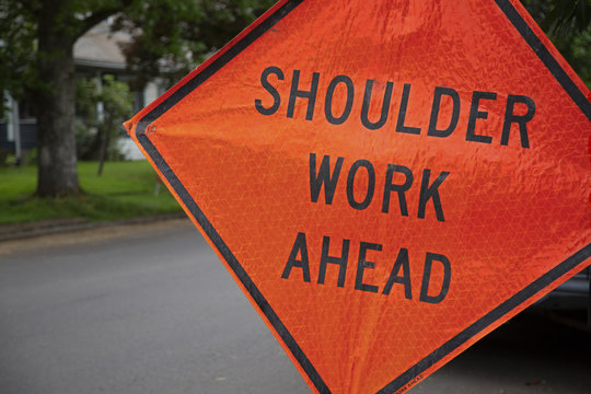 Orange and Black "Shoulder Work Ahead" Sign in Residential Neighborhood, Daytime