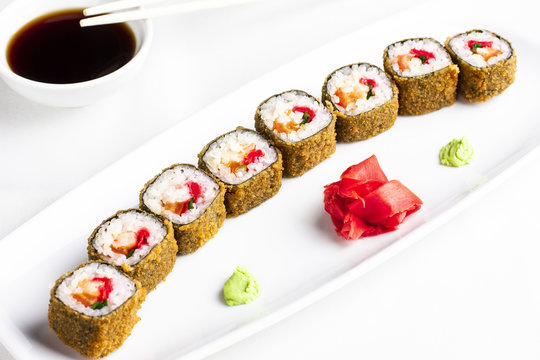 Japanese sushi rolls with crabmeat on white background