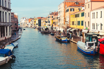 Fototapeta na wymiar Venetian channel with ancient houses and boats