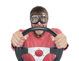 Bearded man in stylish goggles with steering wheel isolated on white background, car driver concept