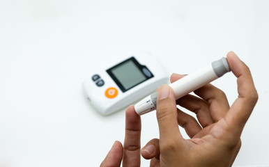 Miniature people: Glucose meter with lancet. Image use for medicine, diabetes, health care concept.