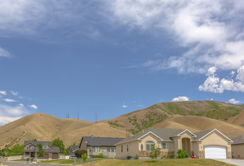 Suburban homes with hills behind and copy space