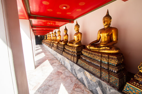 Wat Pho or Wat Phra Chetuphon buddhist temple . golden buddha statue sitting . line pattern of old historic architecture . famous ancient grand palace in Bangkok Thailand , asian travel landmark .