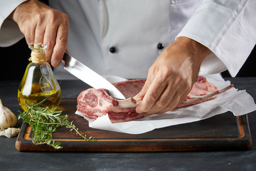 Chef cutting lamb meat with knife on wooden board