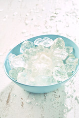 Blue bowl filled with frozen ice cubes
