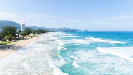 Beautiful wave crashing on sandy shore at karon beach in phuket thailand,aerial view drone shot.