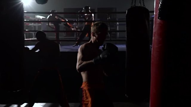 Kickboxers preparing for competitions . Slow motion