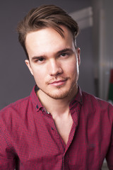 Obraz premium Studio portrait of young man on a dark background