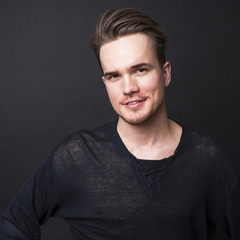 Studio portrait of young man on a dark background