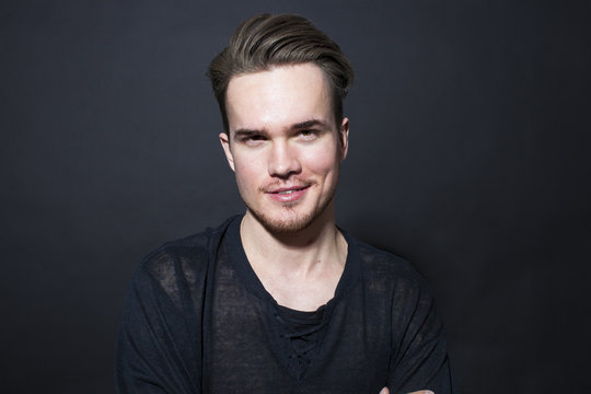 Studio portrait of young man on a dark background