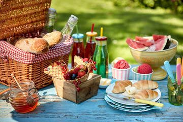 Fruit, bread, honey and ice cream on picnic table - obrazy, fototapety, plakaty