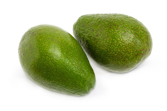 Two whole avocado fruits on a white background