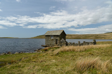 Ruined boathouse on shore of Devoke Water, Lake District