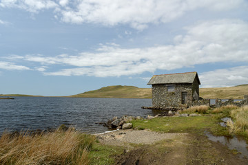 Ruined boathouse on shore of Devoke Water, Lake District