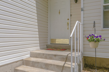 White door on a white house with stairs