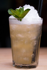 Cool lemonade in glass on wooden table in Summer