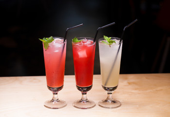 Close up three glasses of soft drink. Three different summer lemonade with mint