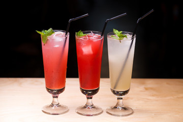 Close up three glasses of soft drink. Three different summer lemonade with mint
