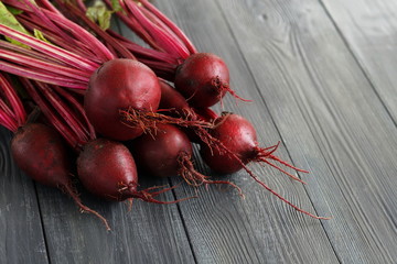 Fresh organic beets, beetroots on grey rustic wooden background. Close up. Copy space