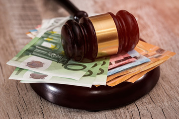 Judge's gavel on stack of euro banknotes