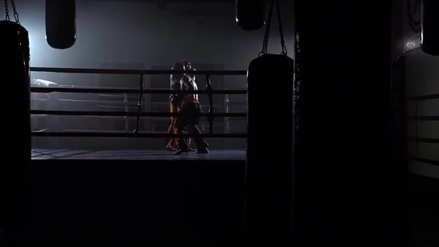Two guys in the ring fight . Slow motion