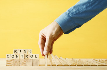 image of male hand stopping the domino effect. executive and risk control concept.