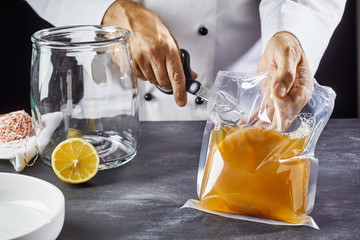 Man opening bag with kombucha SCOBY