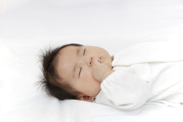 Fototapeta na wymiar 熟睡する新生児の横顔アップ