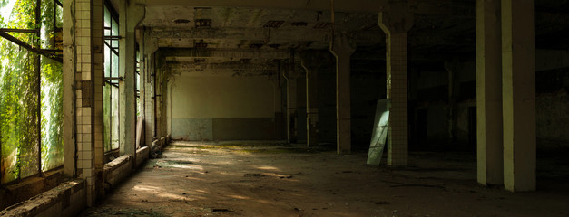 Industrial interior at the old electronic devices factory with big windows and empty floor....