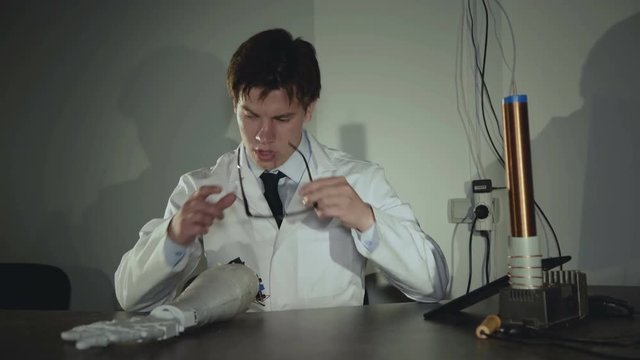 The scientist testing the robotic hand in the lab. 4K
