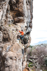 A man climbs the rock.