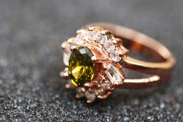 green gem stone and diamond on gold ring