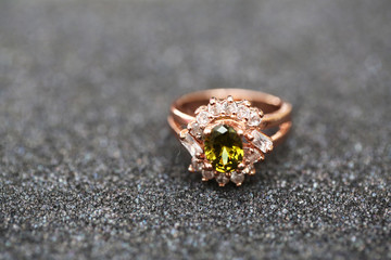 green gem stone and diamond on gold ring