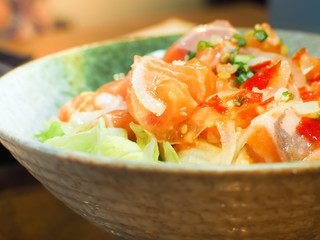 Japan salmon spicy salad with lemon juice, herbs and fresh chili.