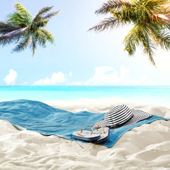 Towel background on sand and free space for your decoration. Summer landscape with palms 