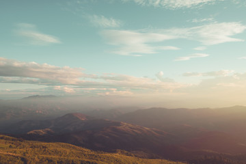 Autumn mountain landscape under  sky with clouds in sunlight. vintage  filter effect.