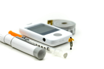 Fototapeta premium Miniature people : Doctor and patient with Glucose meter diabetes test and Syringe with measuring tape,concept of diabetes, healthy lifestyles and nutrition