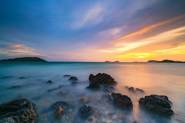 Fototapeta na wymiar Long exposure shot of rocks on the sea at sunset