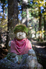 Statue with spider in Okunoin Cemetary, Koyasan. Japan