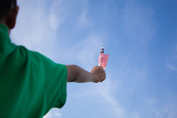 Independence Day concept. A happy and proud boy holding Malaysian flag.
