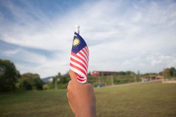 Independence Day concept. A happy and proud boy holding Malaysian flag.