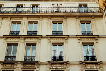 Paris residential buildings. Old Paris architecture, beautiful facades, typical french houses. Famous travel destinations in Europe. Background. City life, lifestyle and expensive real estate concept