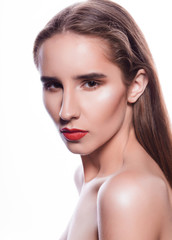 Fototapeta premium Closeup portrait of serious brunette girl with bright makeup, posing on a white background