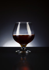cognac glass on a dark bg studio photo shot